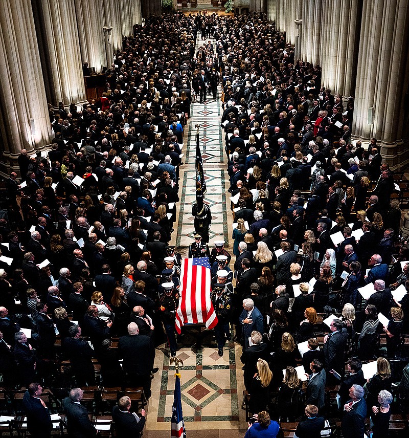 The flag-draped casket of former President George H.W. Bush is carried out by a military honor guard during a State Funeral at the National Cathedral, Wednesday, Dec. 5, 2018, in Washington. (Doug Mills/The New York Times via AP, Pool)
