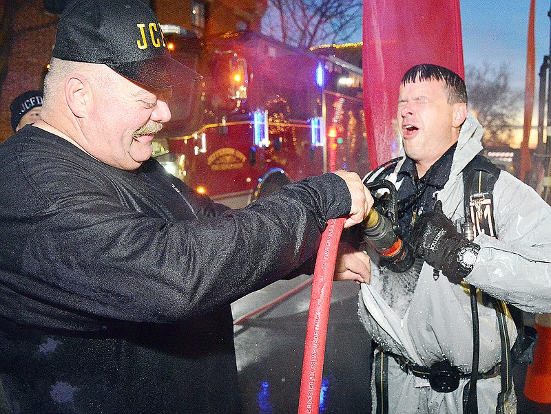 Fire Chief Matt Schofield, right, is hosed down by Darren Reuter after taking the polar plunge Wednesday, Dec. 5, 2018, during the Power Hour Plunge Fundraiser downtown. Proceeds benefit Special Olympics Missouri.