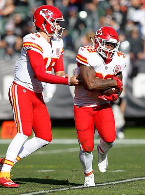 Chiefs running back Spencer Ware takes a handoff from Patrick Mahomes during last Sunday's game against the Raiders in Oakland, Calif.