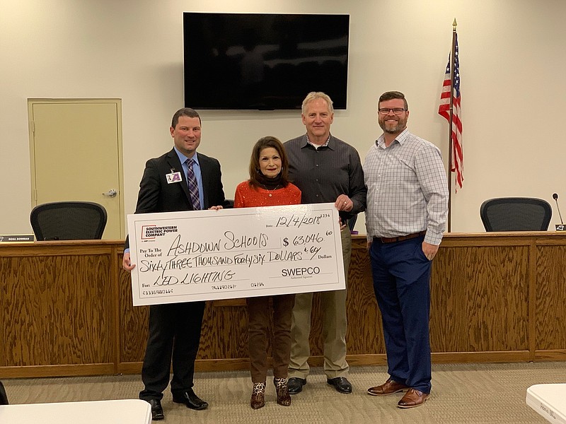 As part of the partnership with SWEPCO and Clear Energy, the Ashdown School District recently completed a districtwide LED lighting retrofit and heating and air system controls upgrade project. As a result, the district will have significant savings in utility bills for years to come. SWEPCO recently extended a $63,046.60 incentive check to the district. Shown are, left to right: Superintendent Casey Nichols; Board Member Rosa Bowman; Gregory Perkins, SWEPCO Consumer & Industrial Program coordinator; and Josh Meyer, business development for Clear Energy. (Submitted photo)
