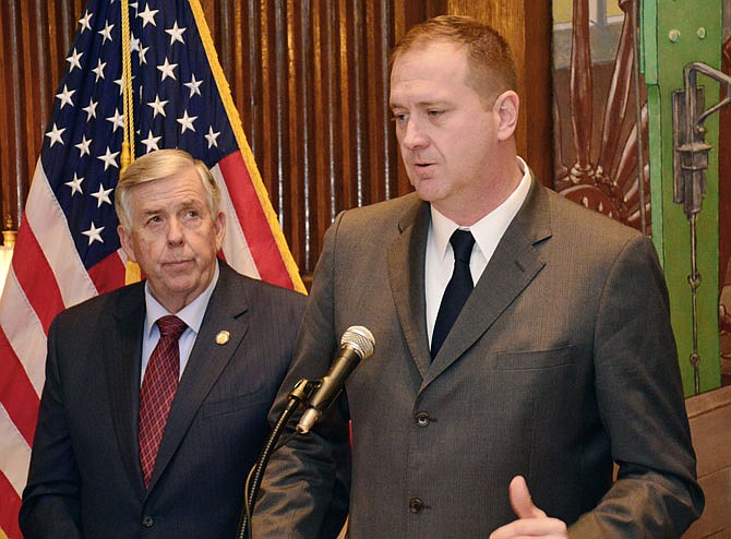 Eric Schmitt, current state treasurer and incoming attorney general, right, and Gov. Mike Parson hold a news conference Friday at the Missouri State Capitol regarding Medicaid fraud.