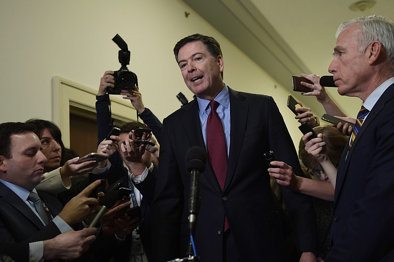 Former FBI Director James Comey, center, standing with his attornery David Kelley, right, speaks to reporters on Capitol Hill in Washington, Friday, Dec. 7, 2018, following his appearance before a closed-door hearing with the House Judiciary and House Oversight committees. (AP Photo/Susan Walsh)