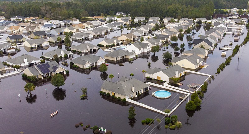 FILE - In this Sept. 24, 2018 file photo, the Polo Farms neighborhood off S.C. Highway 905 is largely underwater, in Longs, S.C., due to Hurricane Florence's deluge. South Carolina's governor says the state's delegation will be able to request more funds to provide relief following Hurricane Florence. In a letter obtained Saturday, Dec. 8, 2018, by The Associated Press, Gov. Henry McMaster told U.S. Rep. Tom Rice he was increasing the estimate for community development block grant relief from $108 million to $435 million at Rice's request. (Jason Lee/The Sun News via AP, File)