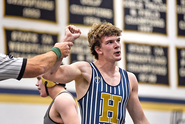 Dustin Luebbert of Helias celebrates after winning a 4-3 decision against Neosho during Friday's competition in the Missouri Duals at Rackers Fieldhouse.