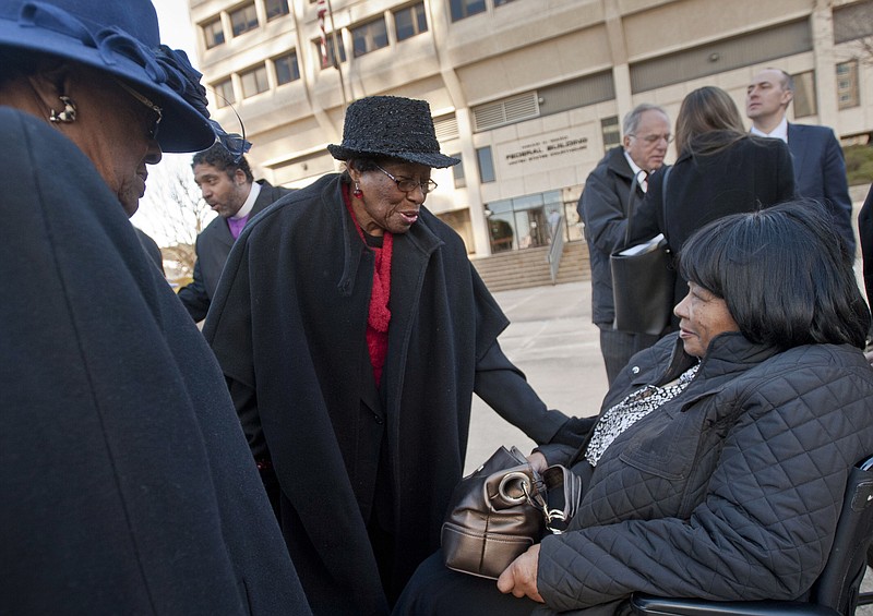 FILE - In this Dec. 12, 2013, file photo, Mary Perry, of Wendell, from left, Rosanell Eaton, of Franklin County, and Carolyn Coleman, of Greensboro, talk after a hearing at the Ward Federal Building in Winston-Salem, N.C., challenging the new North Carolina voting law. African-American North Carolina voting rights activist Eaton has died at age 97. Eaton's daughter, Armenta Eaton, says her mother died Saturday, Dec. 8, 2018, at home in Louisburg, North Carolina (Walt Unks/The Winston-Salem Journal via AP)