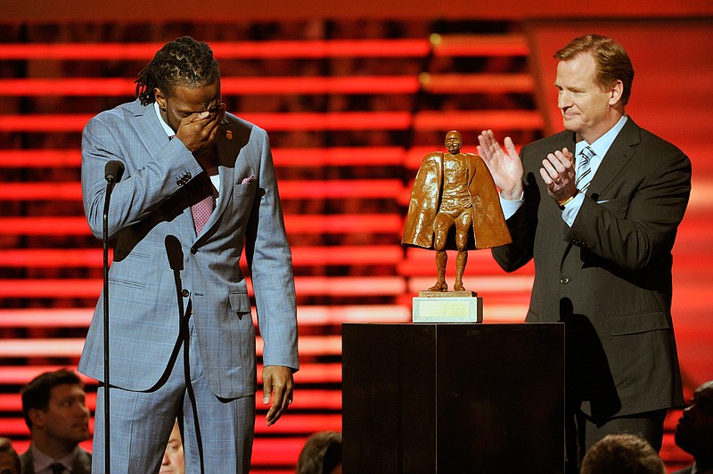 In this Feb. 1, 2014, file photo, Charles Tillman of the Chicago Bears, left, accepts the award for Walter Payton NFL Man of the Year from NFL Commissioner Roger Goodell at the third annual NFL Honors, at Radio City Music Hall in New York. Winning any of the AP's individual NFL awards, from MVP to top rookie, means plenty to players. Being nominated for, no less winning, the Walter Payton Man of the Year award, means more. (Photo by Evan Agostini/Invision for NFL/AP Images, File)