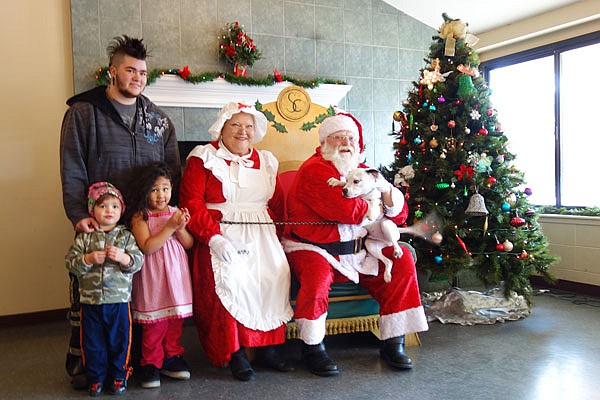 The Evers family — Leon and children Soren, left, and Xiomara — brought their dog Loki to meet Santa and Mrs. Claus during a Callaway County Humane Society fundraiser event. Loki, named for his mischievous nature, did his best to smooch Santa right through the beard.