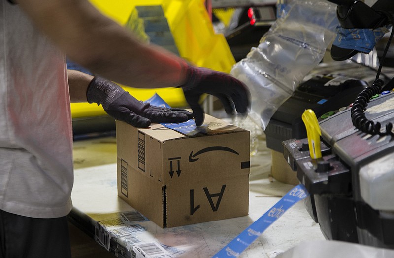 A worker tapes a box while packing items on Cyber Monday at the Amazon Fulfillment Center on Nov. 28, 2016 in San Bernardino, Calif. (Gina Ferazzi/Los Angeles Times/TNS) 