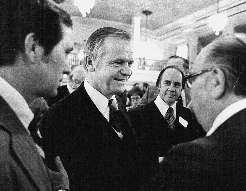 Agriculture Secretary Bob Bergland, center, talks with guests Jan. 23, 1977, at a National Press Club reception.