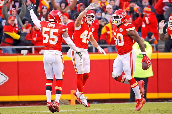 From left, Chiefs linebacker Dee Ford and defensive back Daniel Sorensen celebrate after linebacker Justin Houston recovered a fumble by Ravens quarterback Lamar Jackson for a turnover during the second half of Sunday's game at Arrowhead Stadium.