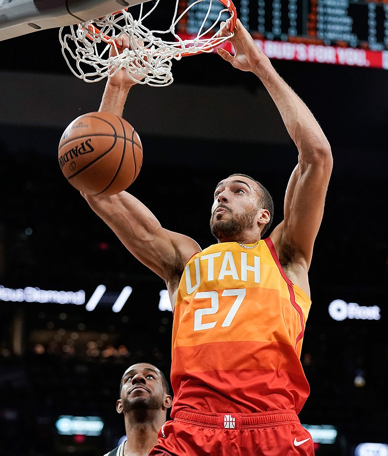 Utah Jazz center Rudy Gobert dunks as San Antonio Spurs forward LaMarcus Aldridge on Sunday in San Antonio. 
