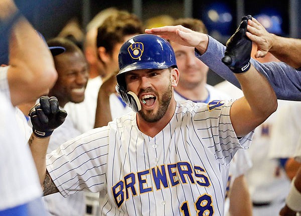 In this Sept. 14 file photo, Brewers third baseman Mike Moustakas is congratulated after hitting a home run during the seventh inning of a game against the Pirates in Milwaukee.