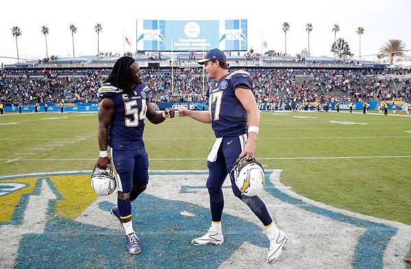 Chargers quarterback Philip Rivers (right) celebrates with teammate Melvin Ingram after Sunday's 26-21 win against the Bengals in Carson, Calif.