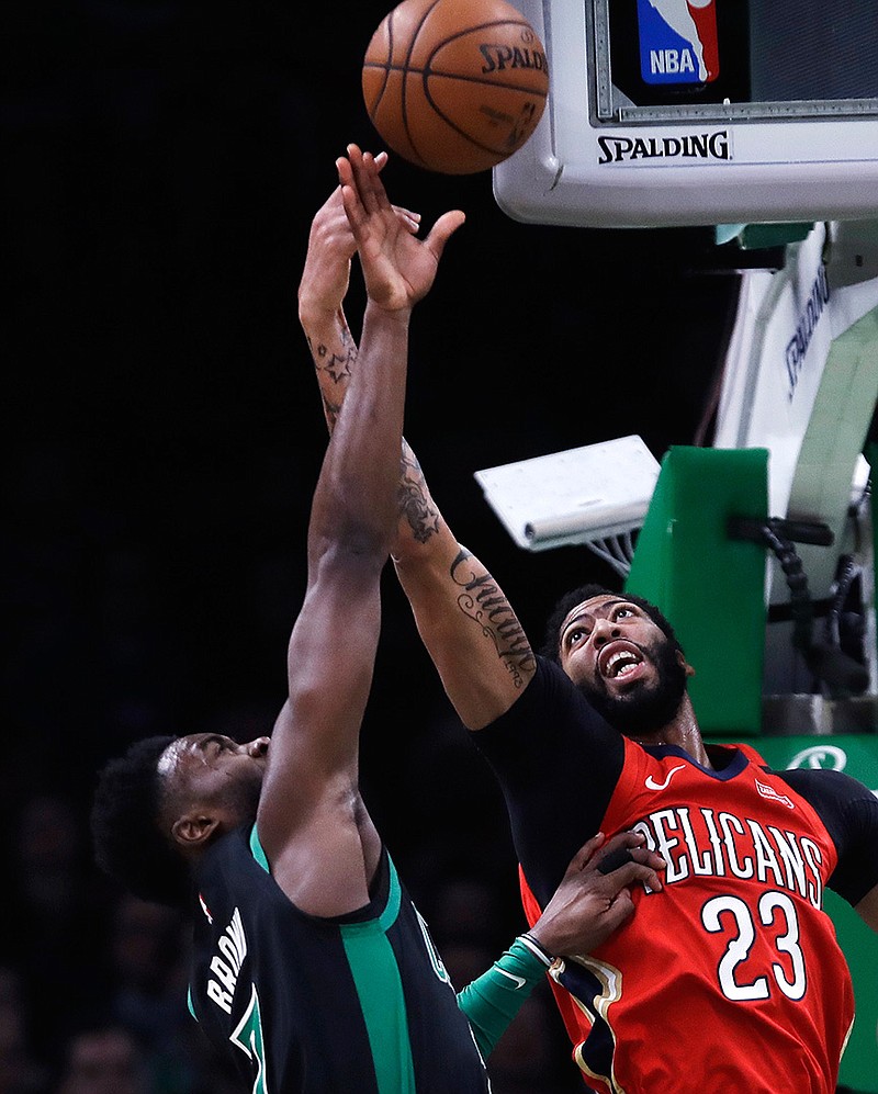 New Orleans Pelicans forward Anthony Davis (23) and Boston Celtics guard Jaylen Brown (7) battle for a rebound during the first quarter Monday in Boston.