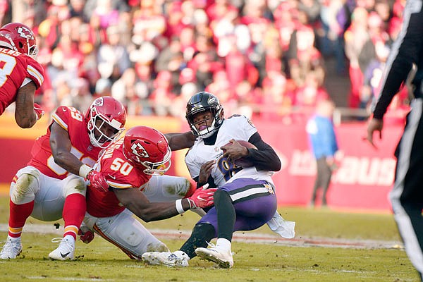 Chiefs linebackers Justin Houston (50) and Reggie Ragland (59) sack Ravens quarterback Lamar Jackson during Sunday's game at Arrowhead Stadium.