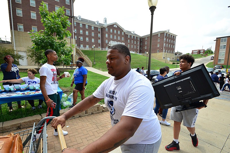 In this Aug. 18, 2018 photo, D'Angelo Bratton-Bland, Lincoln University Student Government Association president, helps Nadaniel Johnson (hauling a TV set) in his transition into Dawson Hall for the start of the new school year. Bratton-Bland was shot and killed in the 200 block of Dawson Street in Jefferson City as he apparently walked past a home where "drug activities" were occurring, police reported. They said he was a victim who did nothing to contribute to his death.