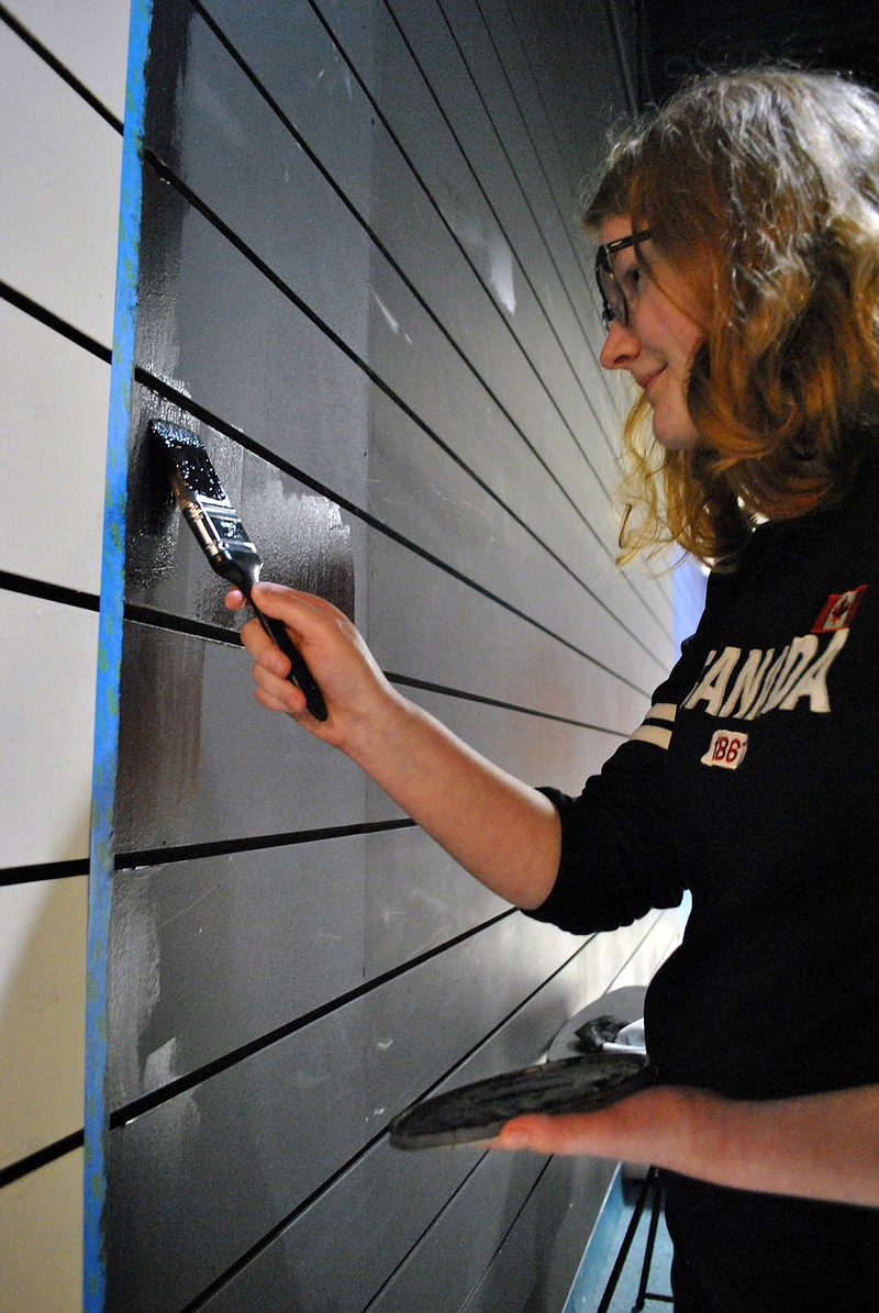 (Photo by Samantha Pogue/News Tribune) Shelby Orme, a student at Itsy Bitsy Broadway, paints the wall to the theater during a painting party and "The First Christmas" set building event Dec. 6. 