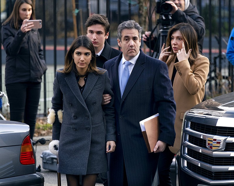 Michael Cohen, second from right, President Donald Trump's former lawyer, accompanied by his children from left, Samantha and Jake, and his wife Laura Shusterman, right, arrive at federal court for his sentencing for dodging taxes, lying to Congress and violating campaign finance laws in New York on Wednesday, Dec. 12, 2018.