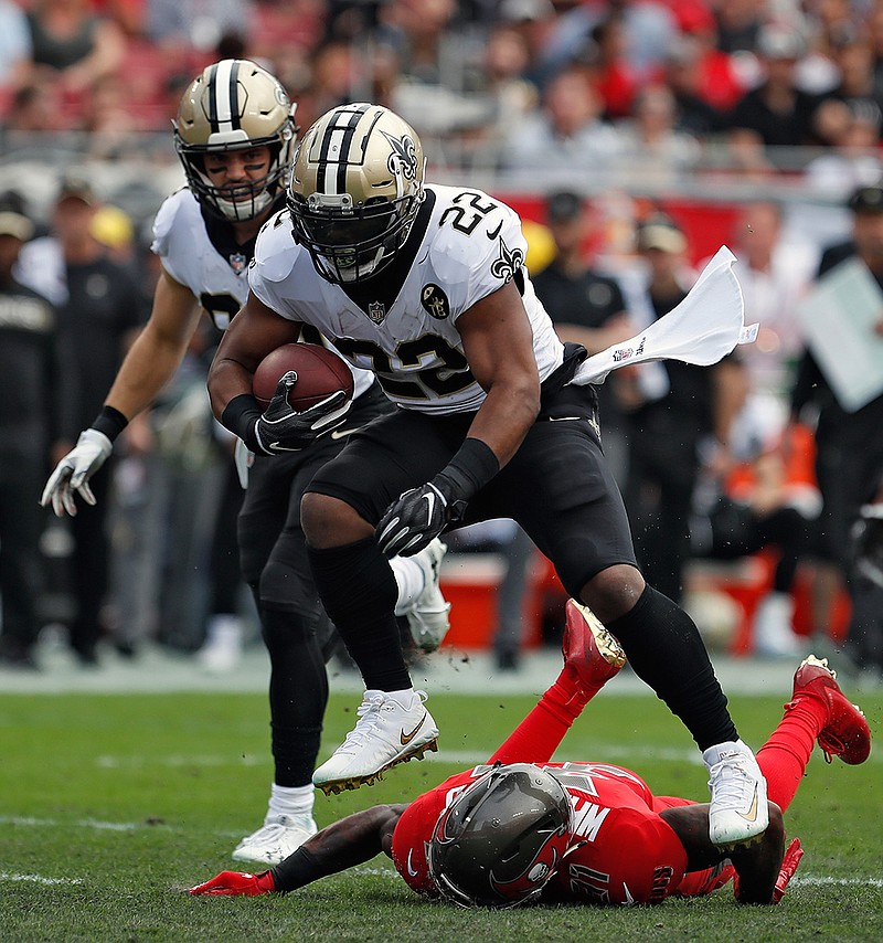 New Orleans Saints running back Mark Ingram (22) leaps over Tampa Bay Buccaneers free safety Jordan Whitehead (31) on a run during the first half of an NFL football game Sunday, Dec. 9, 2018, in Tampa, Fla. (AP Photo/Mark LoMoglio)