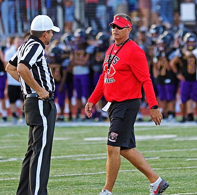 Shannon Jolley talks with an official during last August's Jamboree in Columbia. Jolley was named the first head football coach at Capital City High School on Tuesday.