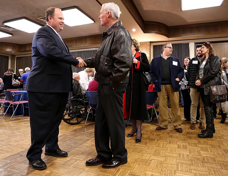 James Henry Russell shakes hands with Robert Irwin during Russell's farewell reception Tuesday at Texarkana College. TC held a reception for Russell where members of the community came to say goodbye and remember the work he's done for the college.