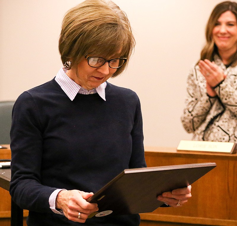 Pleasant Grove yearbook adviser Charla Harris looks at her National Adviser of the Year award Tuesday at the Pleasant Grove central services building.