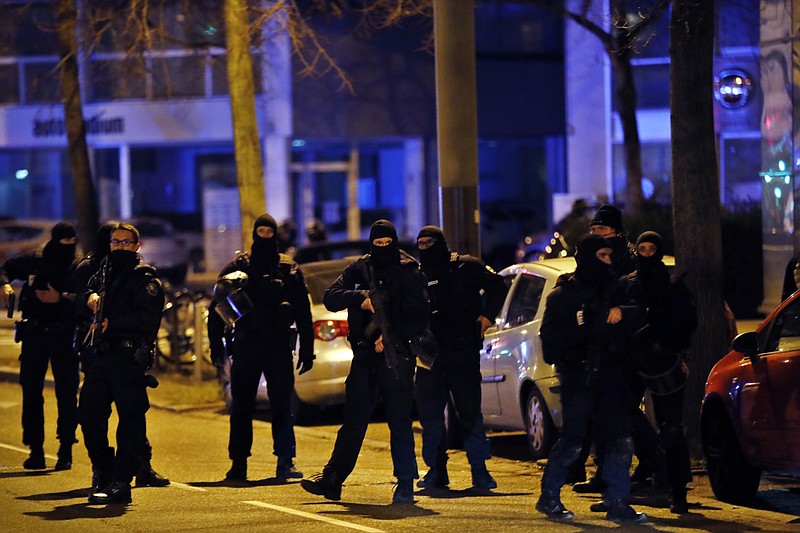 French police officers stand in the Neudorf neighborhood, in Strasbourg, eastern France, Thursday, Dec. 13, 2018. French police conducted an intense but ultimately fruitless search operation Thursday in the Strasbourg neighborhood where a suspected gunman who killed three people and wounded 13 near a popular Christmas market was last seen. (AP Photo/Christophe Ena)
