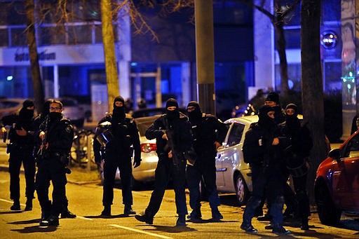 French police officers stand in the Neudorf neighborhood, in Strasbourg, eastern France, Thursday, Dec. 13, 2018. French police conducted an intense but ultimately fruitless search operation Thursday in the Strasbourg neighborhood where a suspected gunman who killed three people and wounded 13 near a popular Christmas market was last seen. (AP Photo/Christophe Ena)