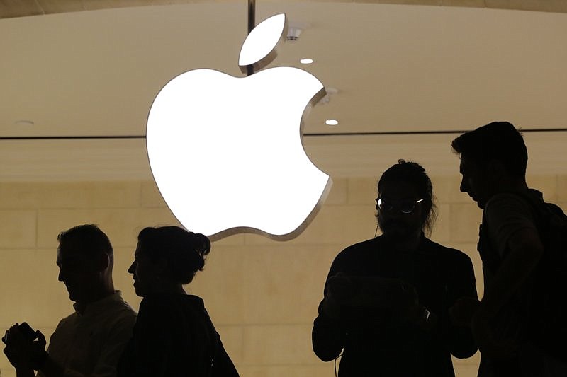 In this May 31, 2018, file photo, customers enter the Apple store, in New York. Apple will build a $1 billion campus in Austin, Texas, break ground on smaller locations in Seattle, San Diego and Culver City, California, and over the next three years will expand in Pittsburgh, New York and Colorado.