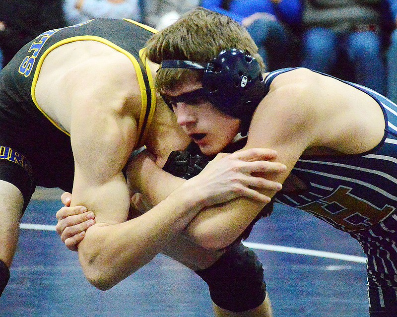 Nikolai Careaga of Helias gets a grip on Borgia's Grant Straatmann on Wednesday at Rackers Fieldhouse.