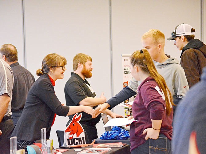 Administrations representative Molly Jettmar, left, introduces herself to high school students from Nichols Career Center on Wednesday as she discusses the types of programs offered at the University of Central Missouri during the center's career fair at The Linc. Roughly 250 students, consisting of mostly juniors and seniors, attended the fair and had a chance to speak with 24 representative groups about their future careers. Nichols Career Center plans to partner with The Linc to host their career and interview fairs until construction of for a large enough boardroom is complete at Nichols sometime next year. 