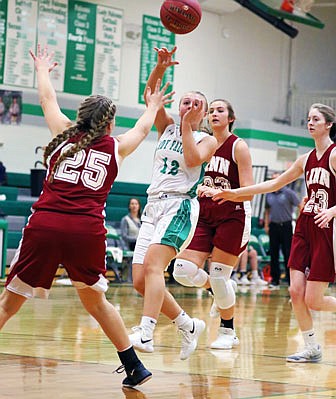 Blair Oaks' Bailey Rissmiller makes a pass over Linn's Jessica Keilholz during Thursday's game in Wardsville.