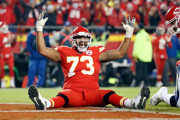 Chiefs offensive tackle Jeff Allen celebrates a touchdown by teammate Damien Williams during the second half of Thursday night's game against the Chargers at Arrowhead Stadium.