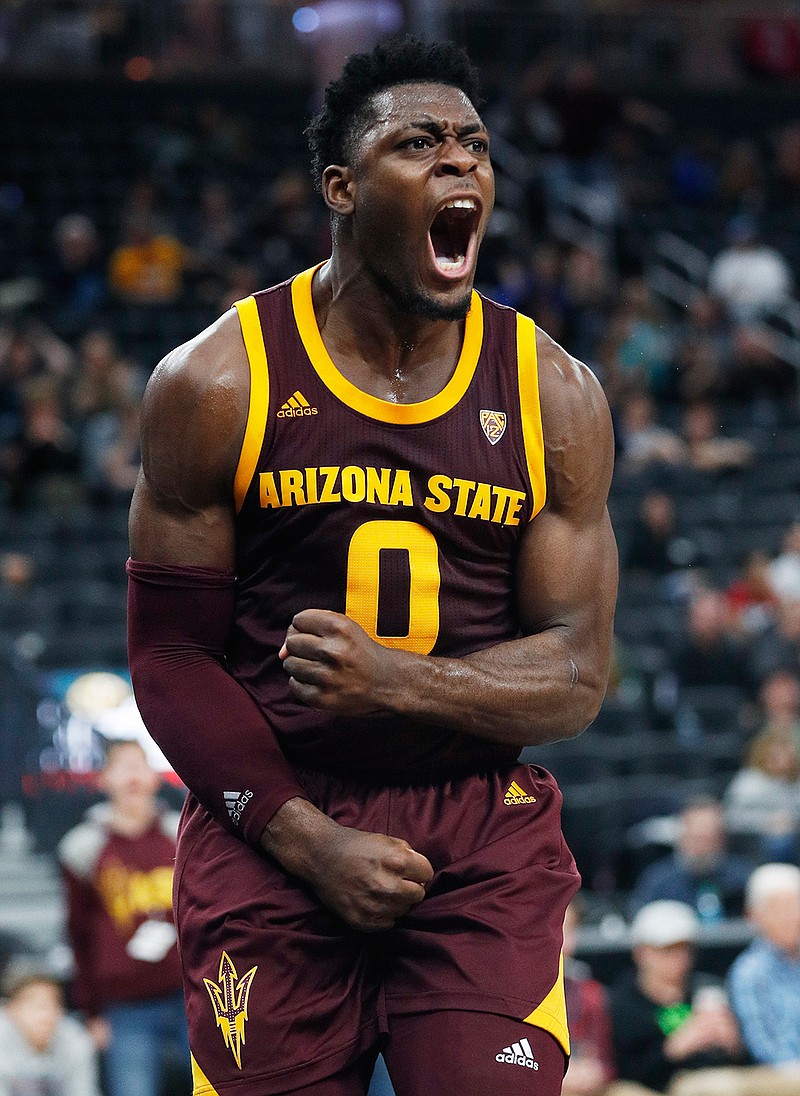  In this Nov. 21, 2018, file photo, Arizona State 's Luguentz Dort celebrates after scoring during the second half of an NCAA college basketball game against Utah State in Las Vegas. At 6-foot-4, 215 pounds, he's built like linebacker on the Arizona State football team, not some scrawny teenager disdainfully bumped out of the lane on a basketball court. (AP Photo/John Locher, File)