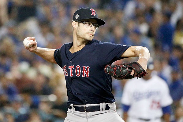 Joe Kelly throws to the plate during a relief appearance for the Red Sox against the Dodgers in Game 3 of the World Series on Oct. 26 in Los Angeles. Kelly, a free agent, has agreed to a contract with the Dodgers.