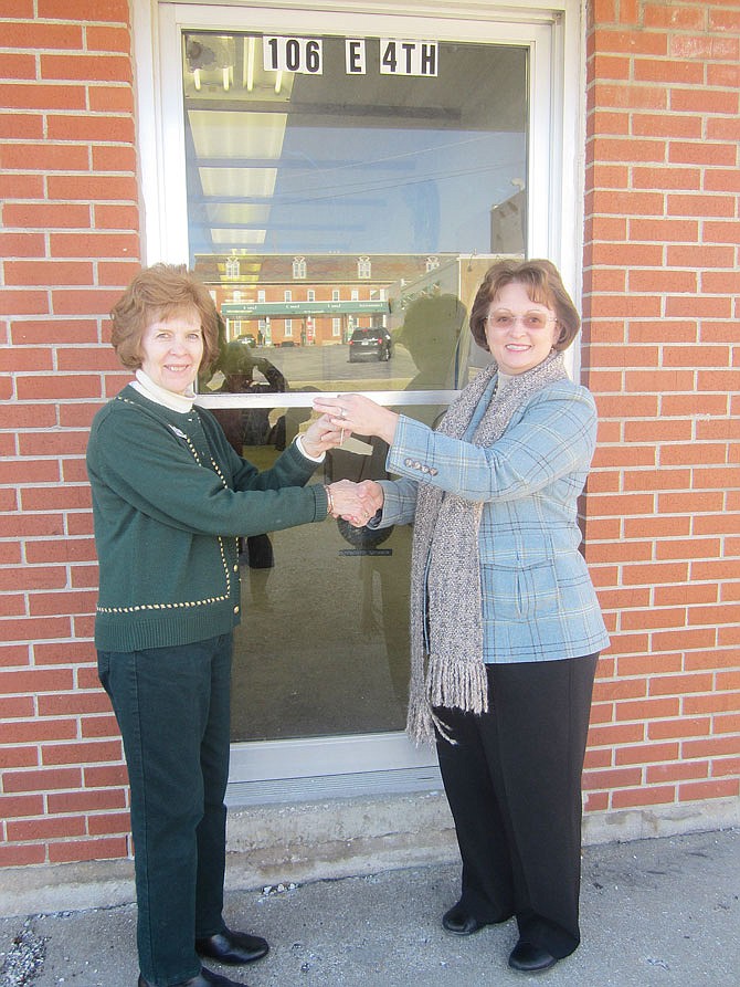 KCHS Museum Director Barb Huddleston, left, receives keys to the new second location from Kim Barnes, president and CEO of The Callaway Bank.