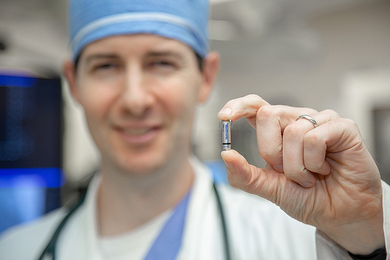 Dr. Kevin Hayes, St. Michael electrophysiology lab medical director and cardiac electrophysiologist, holds up the Micra transcatheter pacemaker, which is about the size of a vitamin pill. It is 93 percent smaller than traditional pacemakers. (Submitted photo)
