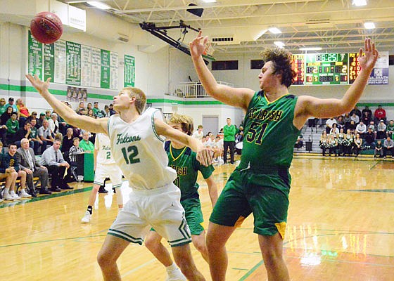 Dru Rackers of Blair Oaks and Wallace Squibb of Springfield Catholic look toward a rebound during Friday night's game in Wardsville.