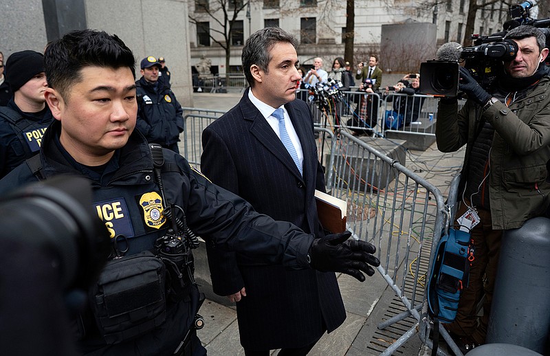 In this Dec. 12, 2018, photo, Michael Cohen, President Donald Trump's former lawyer, leaves federal court after his sentencing in New York. Trump has gone from denying knowledge of any payments to women who claim to have been mistresses to apparent acknowledgement of those hush money settlements  though he claims they wouldn't be illegal.  (AP Photo/Craig Ruttle)