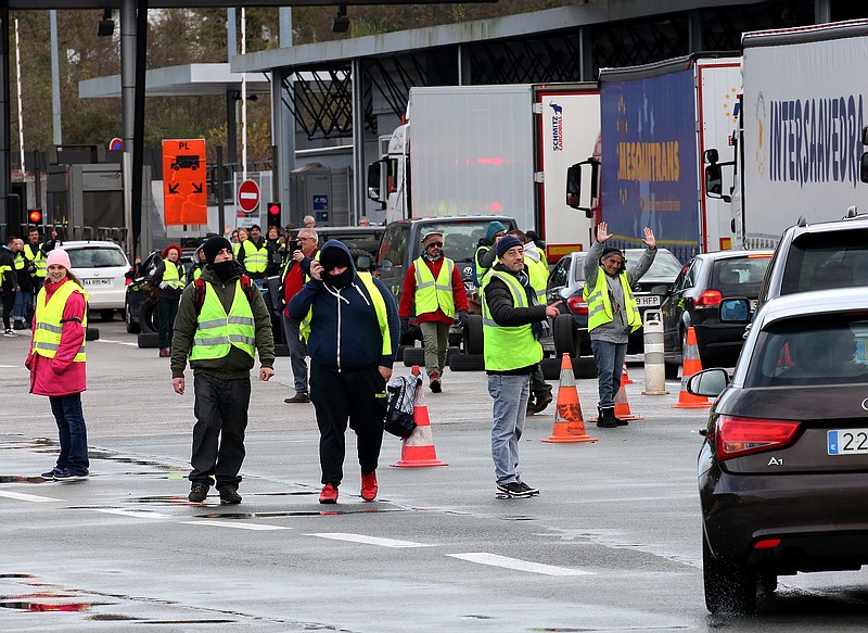 Demonstrators wearing yellow vests on the blocked highway near the French border with Spain, during a protest Saturday, Dec. 15, 2018 in Biriatou, southwestern France. Police have deployed in large numbers Saturday for the fifth straight weekend of demonstrations by the "yellow vest" protesters, with authorities repeating calls for calm after protests on previous weekends turned violent. (AP Photo/Bob Edme)