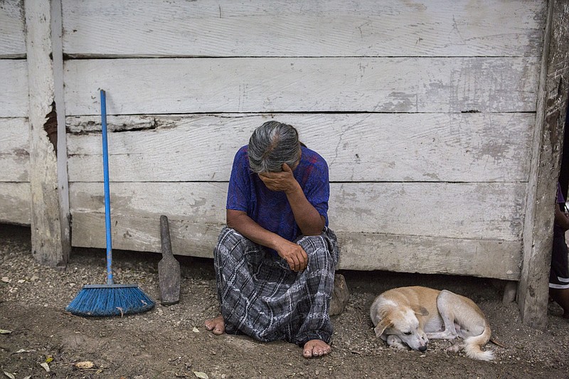 Elvira Choc, 59, Jakelin Amei Rosmery Caal's grandmother, rests her head on her hand in front of her house in Raxruha, Guatemala, on Saturday, Dec. 15, 2018. The 7-year old girl died in a Texas hospital, two days after being taken into custody by border patrol agents in a remote stretch of New Mexico desert. (AP Photo/Oliver de Ros)