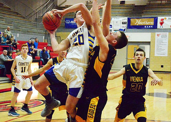 Fatima's Brett Werner takes a contested shot against a Vienna defender during Saturday's game in the Capital City Shootout at Fleming Fieldhouse.