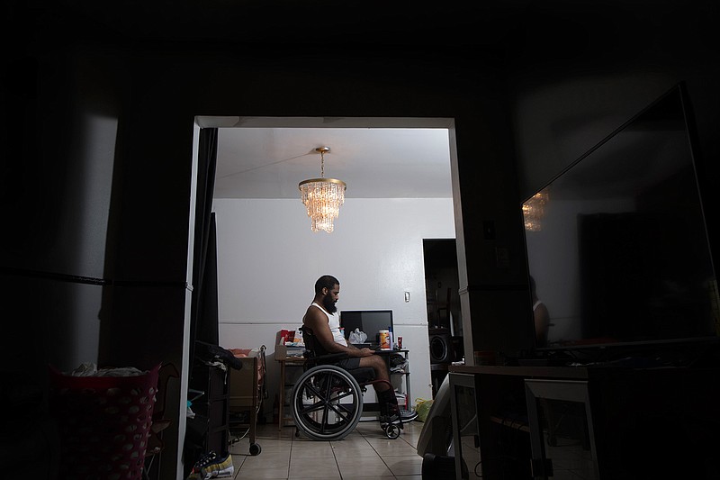 Jalil Frazier is photographed where he is confined to sleep and live on the first floor of his home in the Olney neighborhood on July 18 in Philadelphia, Pa.