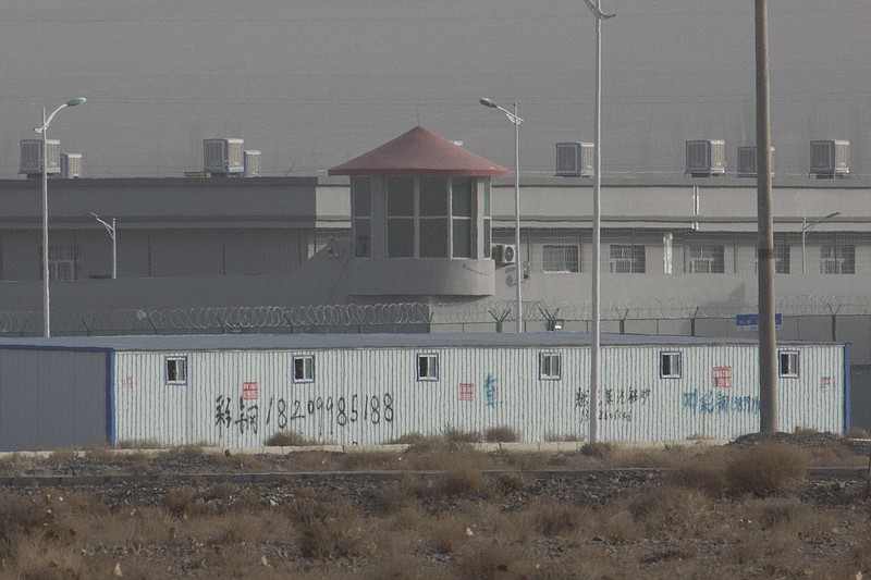 In this Monday, Dec. 3, 2018, photo, a guard tower and barbed wire fences are seen around a facility in the Kunshan Industrial Park in Artux in western China's Xinjiang region. This is one of a growing number of internment camps in the Xinjiang region, where by some estimates 1 million Muslims are detained, forced to give up their language and their religion and subject to political indoctrination. Now, the Chinese government is also forcing some detainees to work in manufacturing, food and service industries, in what activists call "black factories." (AP Photo/Ng Han Guan)