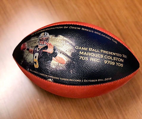 This undated photo provided by the Saints shows a custom made football commemorating quarterback Drew Brees becoming in the NFL's all-time leader in yards passing.