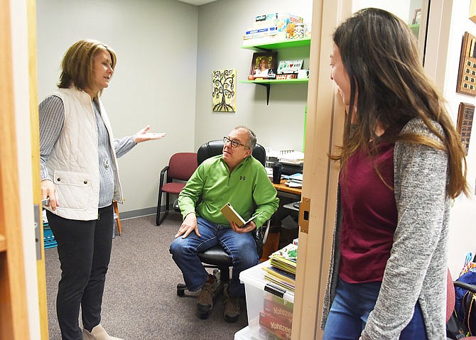 Lee Knernschield, left, and Kelsey Schrimpf, right, visit with Mark Schreiber in his office at Big Brothers Big Sisters. Knernschield is executive director of the organization where Schreiber and Schrimpf are program coordinators respectively for the schools and community.