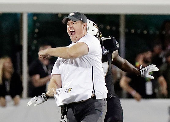 Central Florida head coach Josh Heupel runs on the field and celebrates during the final seconds of the American Athletic Conference championship game against Memphis earlier this month in Orlando, Fla.