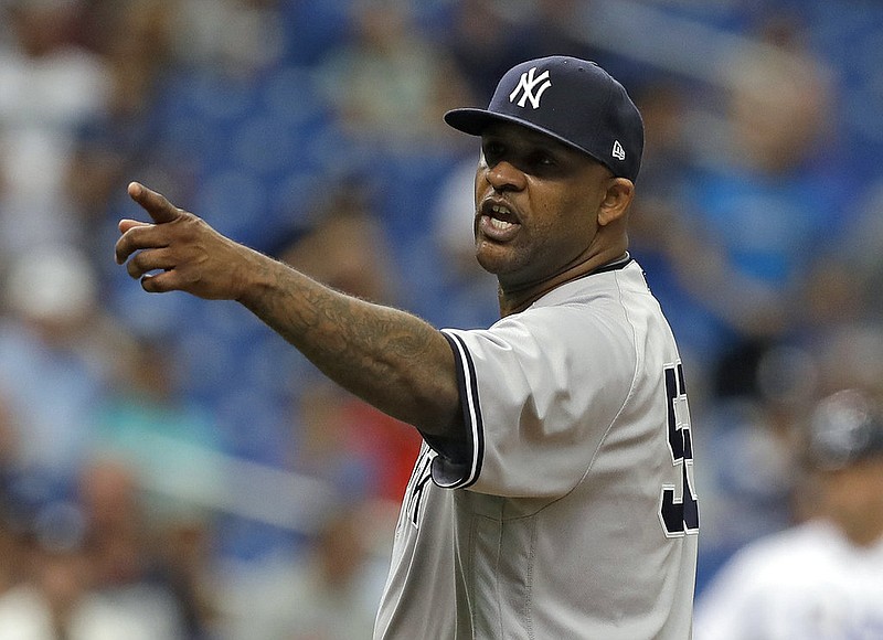 In this Sept. 27, 2018, file photo, New York Yankees' CC Sabathia points at the Tampa Bay Rays dugout after he was ejected for hitting Tampa Bay Rays' Jesus Sucre with a pitch during the sixth inning of a baseball game, in St. Petersburg, Fla. The New York Yankees gave pitcher CC Sabathia a $500,000 performance bonus, even though the 38-year-old left-hander was ejected from his final regular-season start six outs shy of the 155 innings specified for the payment in his contract. 