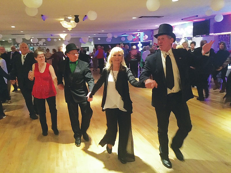 Gerry Tritz/News Tribune
Tom Cwynar leads New Year's Eve revelers on the "Grand March" Sunday night at Capital Ritz.