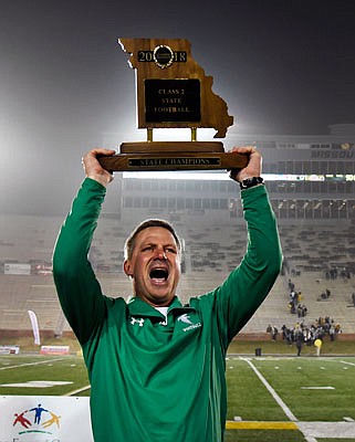 Blair Oaks head coach Ted LePage lifts the state championship trophy after last month's 54-0 win against Lathrop in the title game at Faurot Field. LePage was voted Class 2 Coach of the Year by the Missouri Football Coaches Association.